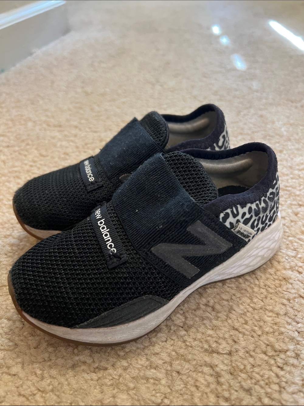 New Balance Kids Black Slip-On Sneakers with White Midsole and Leopard Accent
